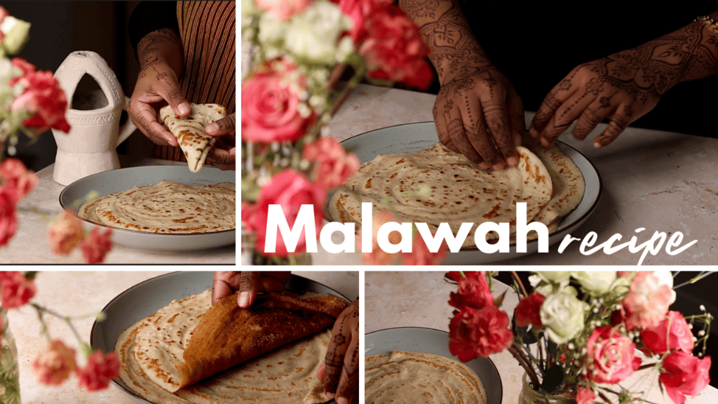 Softly folded Malawah flatbread on a plate with flowers in the foreground.